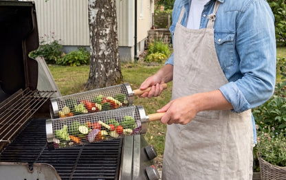 Griller rolling the basket over the grate